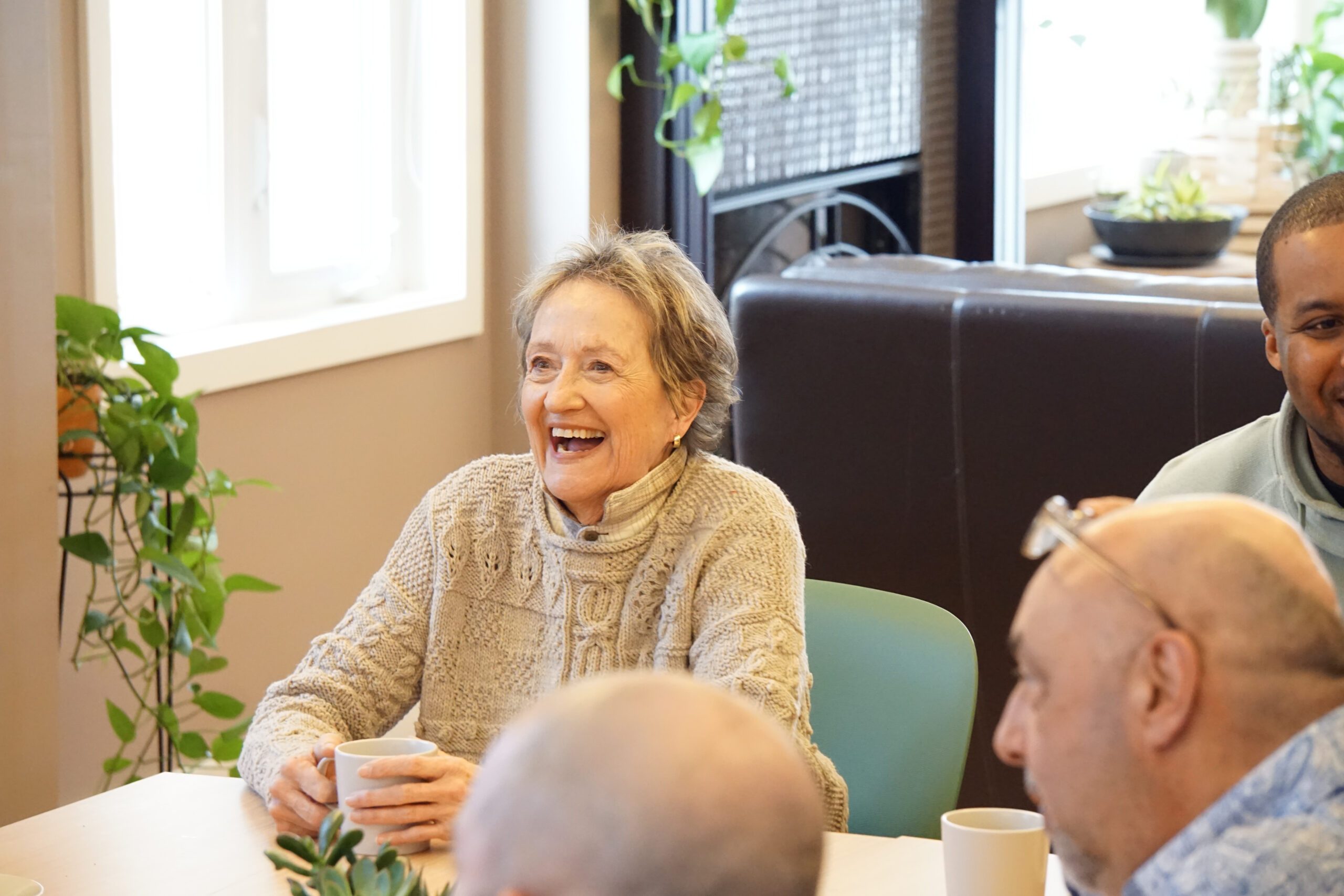 A woman and her grandmother, supported by a caregiver